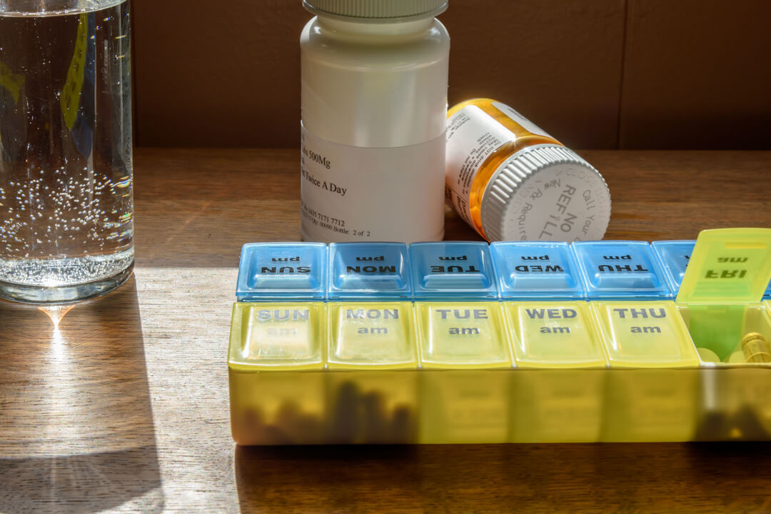 Using a pill organizer for daily medication and supplements